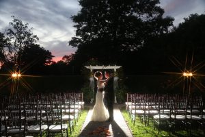 Bride and Groom alone in outdoor garden wedding as dusk