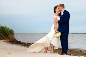 Bride and Groom Kissing in a Romantic Beach Setting